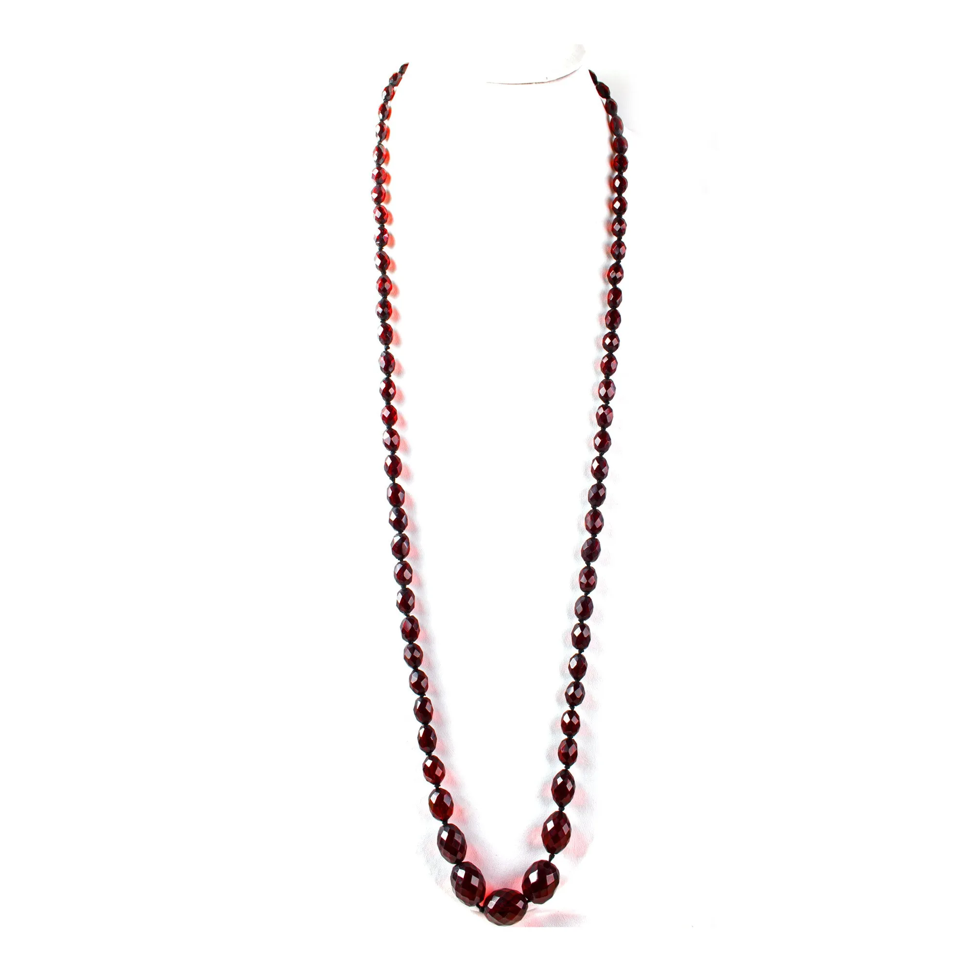 Art Deco long strand of knotted and graduated faceted oval cherry amber Bakelite beads. nlbk789