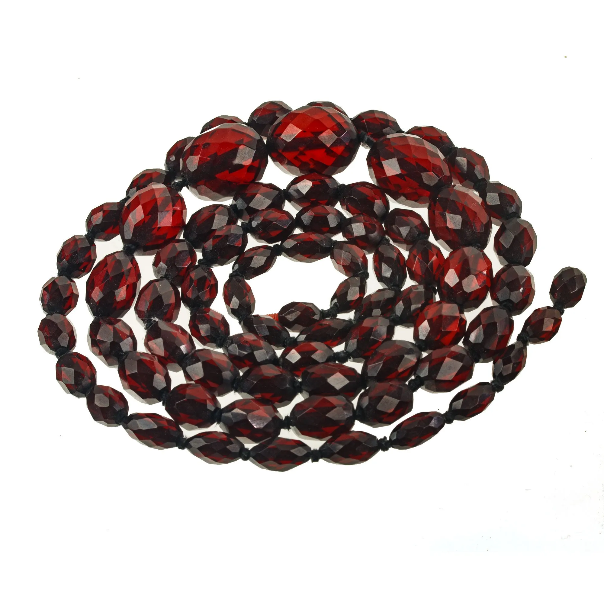 Art Deco long strand of knotted and graduated faceted oval cherry amber Bakelite beads. nlbk789